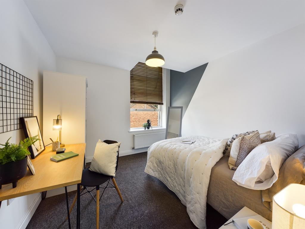 A bright and inviting double bedroom featuring ...