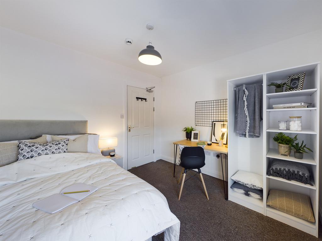 A bright and stylish double bedroom featuring a...