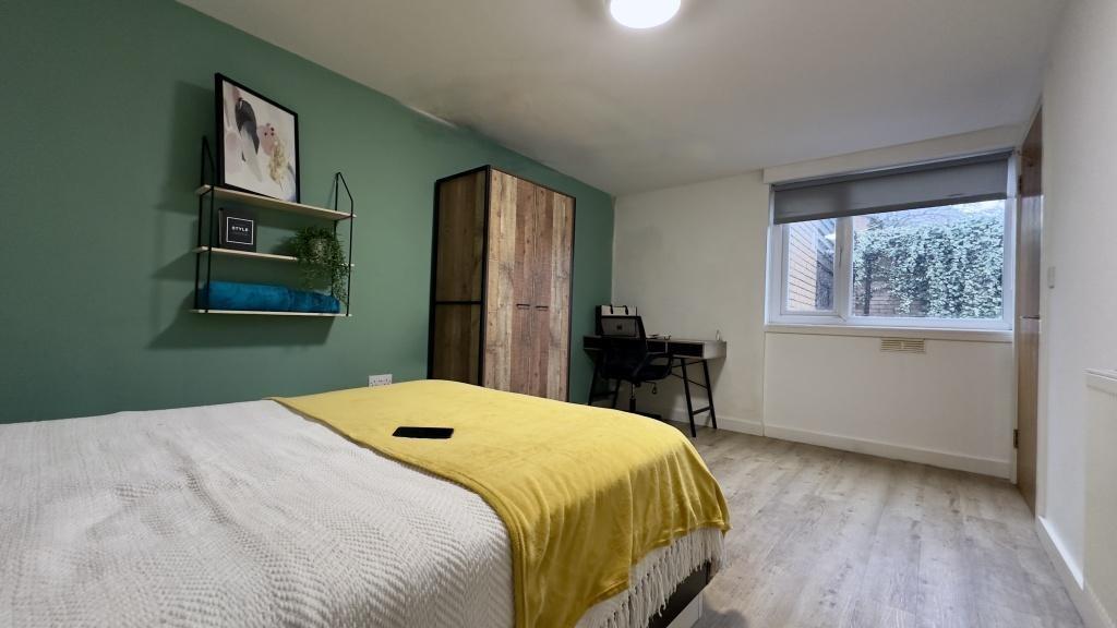 Bright, modern bedroom with a comfortable doubl...