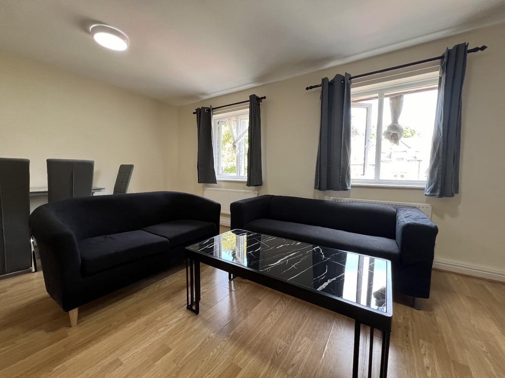 A spacious and modern living room featuring two...