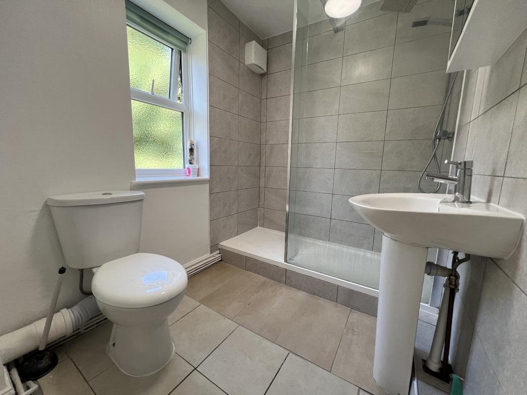 Bright and clean bathroom featuring a toilet, s...