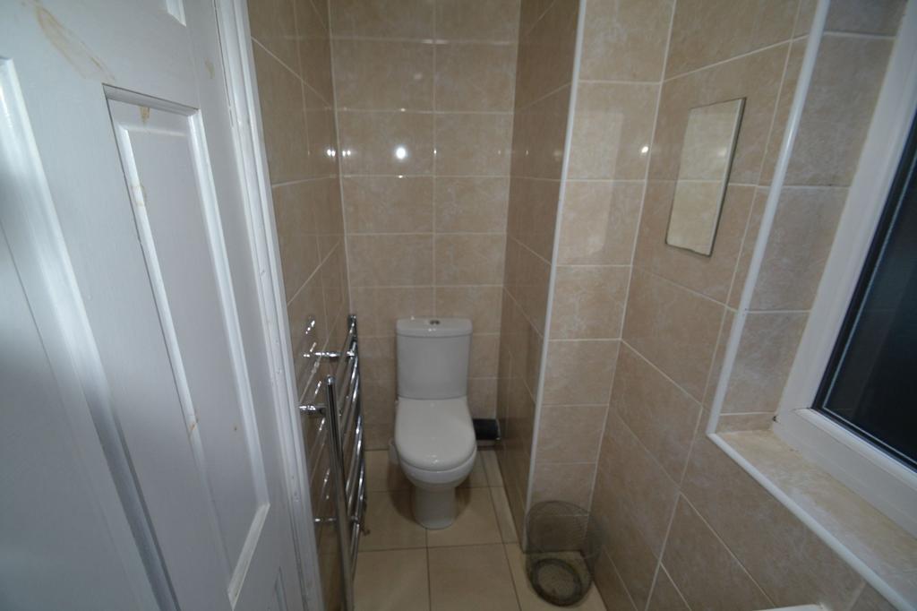 Clean and modern small bathroom with beige tile...
