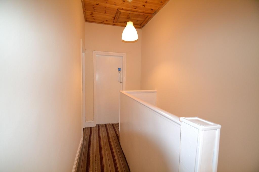 A simple, well-maintained hallway with a warm w...
