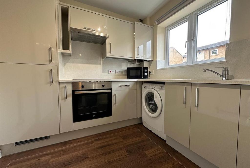 Bright modern kitchen with glossy fitted cabine...