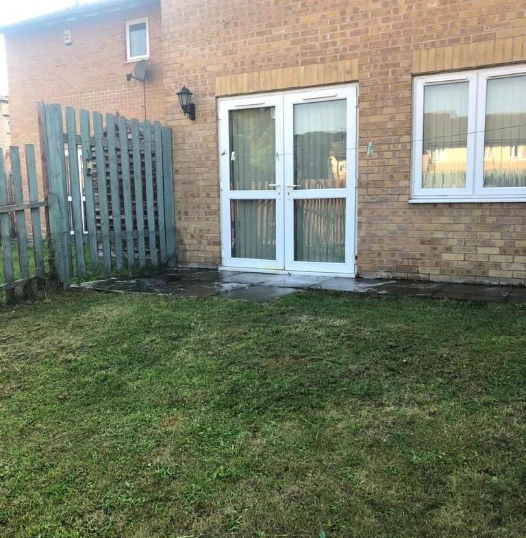Well-kept rear garden with a lawn, paved patio ...