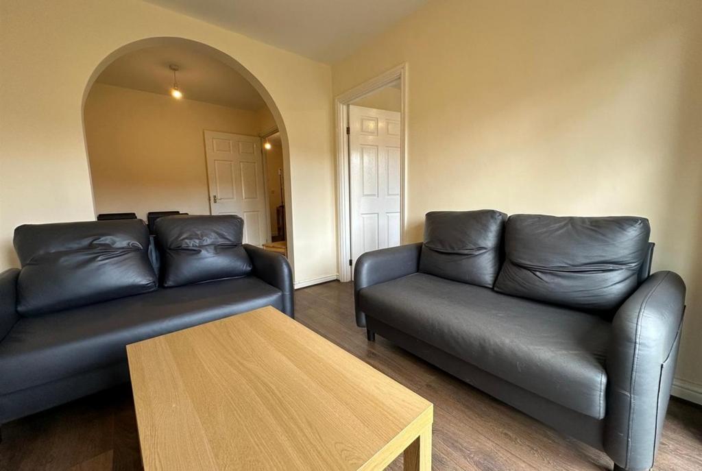 Bright, simply furnished living room featuring ...