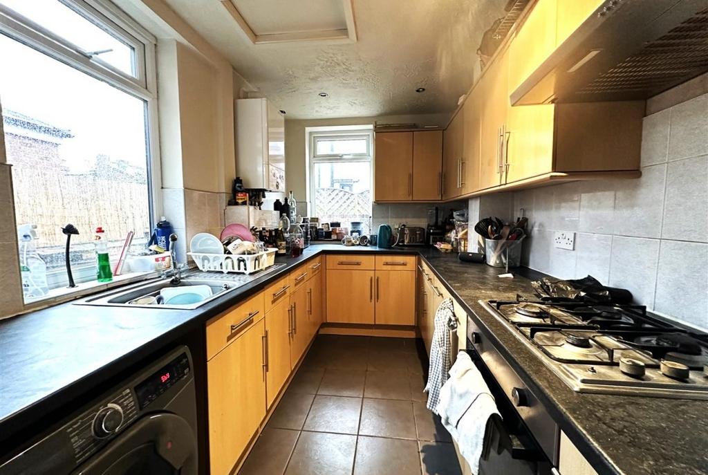 Bright galley kitchen with generous counter spa...