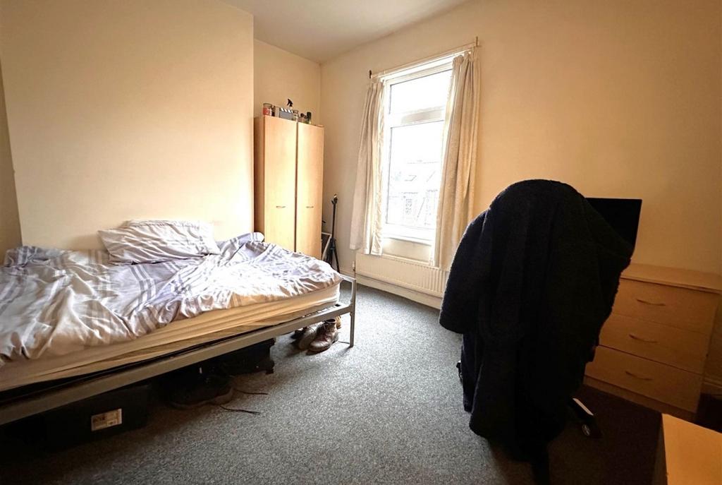 Bright, simply furnished single bedroom with a ...
