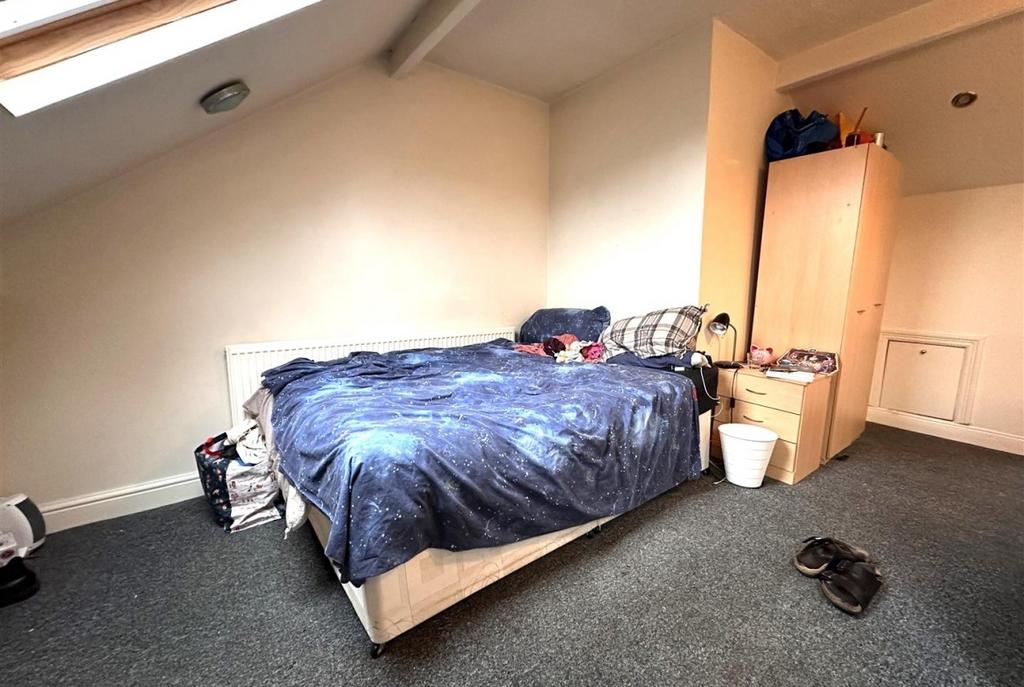 Bright attic double bedroom with a skylight, la...