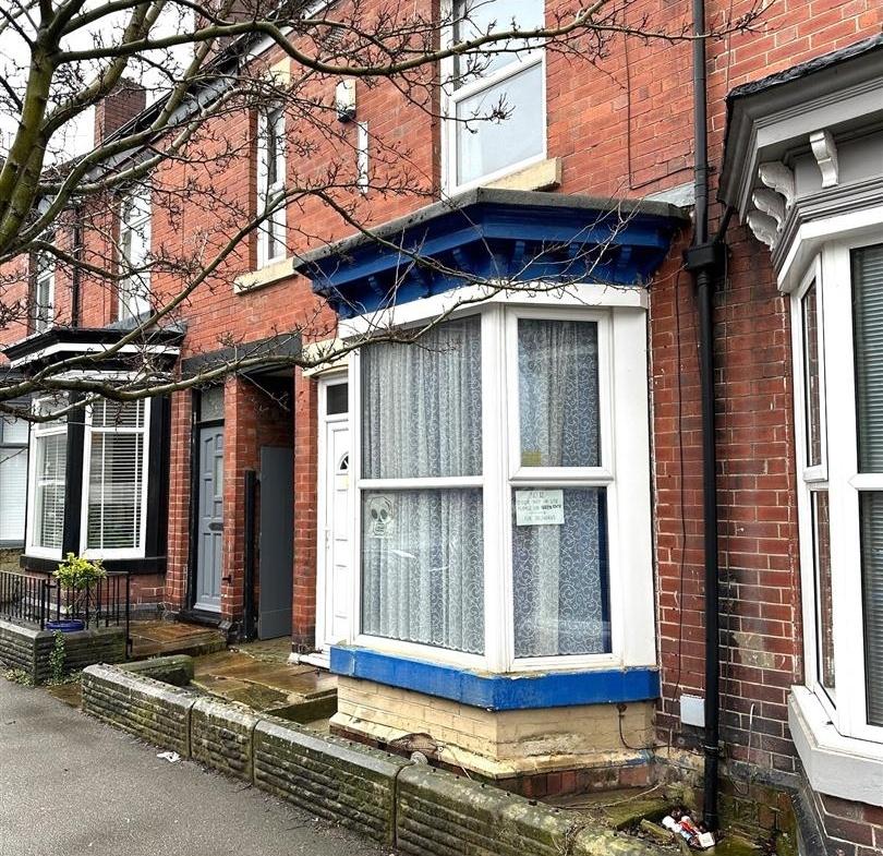 Victorian-style red-brick terraced house with a...