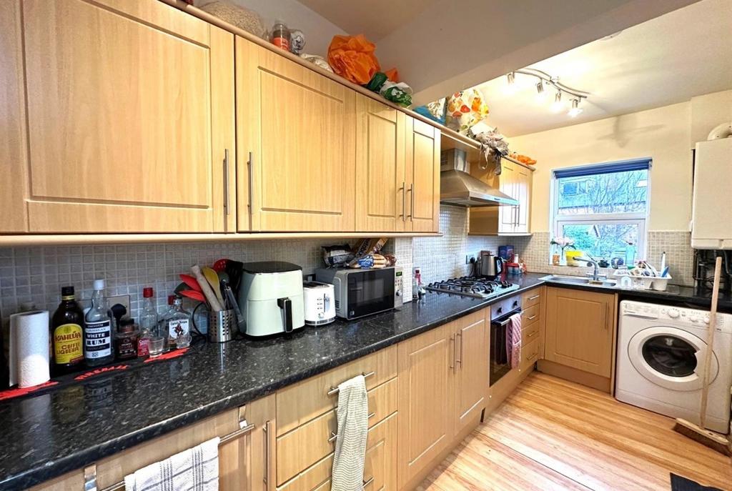 Bright, well-equipped galley kitchen with light...
