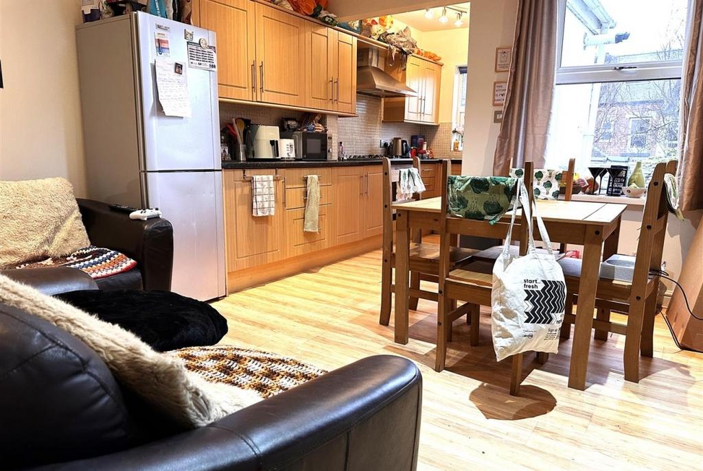 Bright open-plan kitchen and dining area with l...