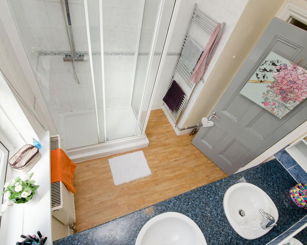Bright, modern bathroom with a glass-enclosed s...