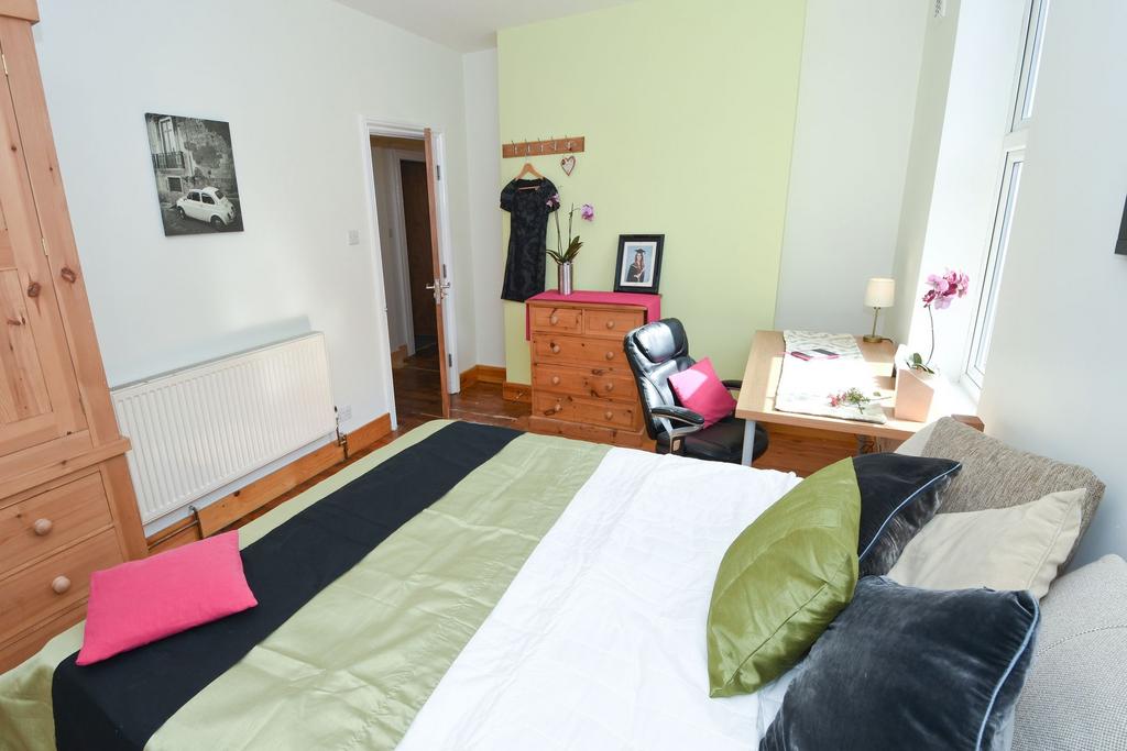 Bright, well-kept bedroom with a comfortable do...