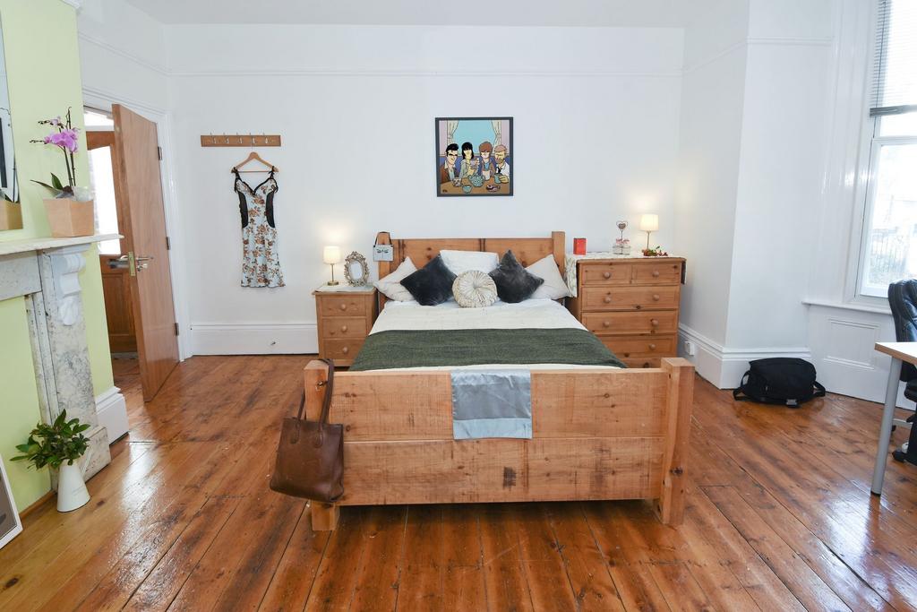 Bright, well-presented bedroom with a solid woo...