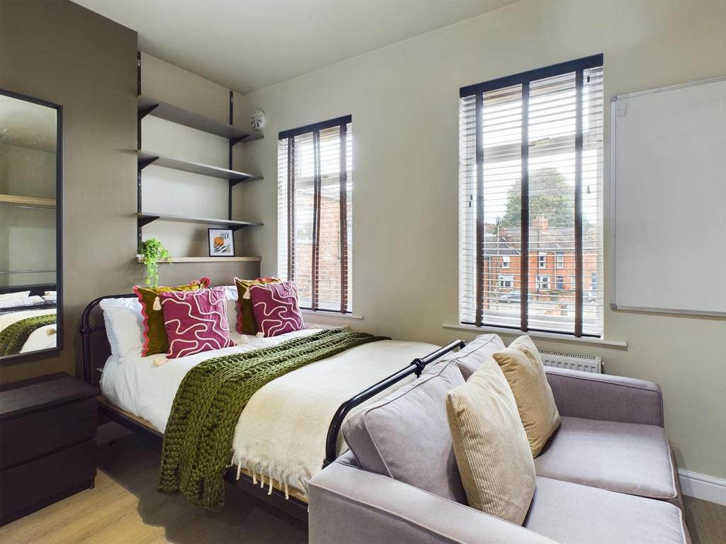 A bright and inviting double bedroom featuring ...