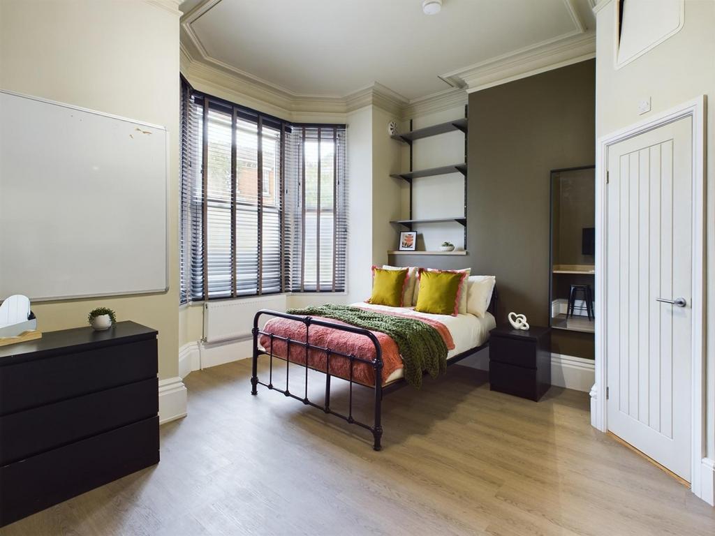 A bright and inviting double bedroom, featuring...
