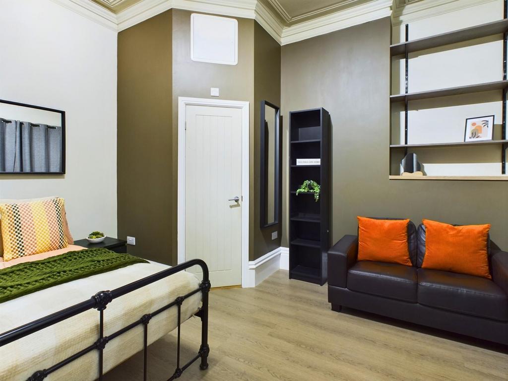 A spacious and stylish double bedroom featuring...