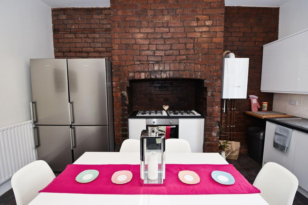 Stylish kitchen with exposed brick fireplace fe...