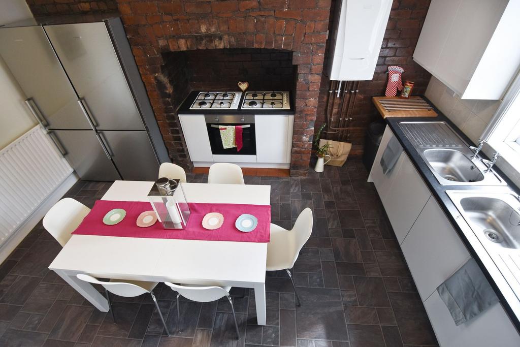 Bright, modern kitchen with a sleek white dinin...