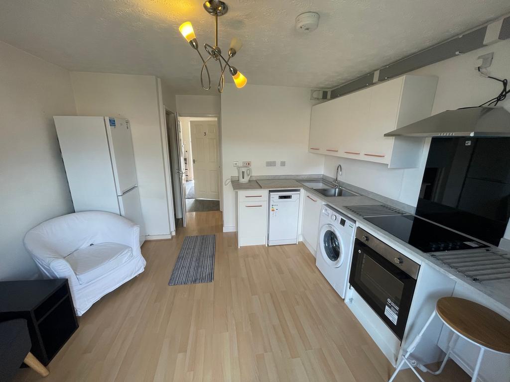 A modern and tidy kitchenette equipped with ess...