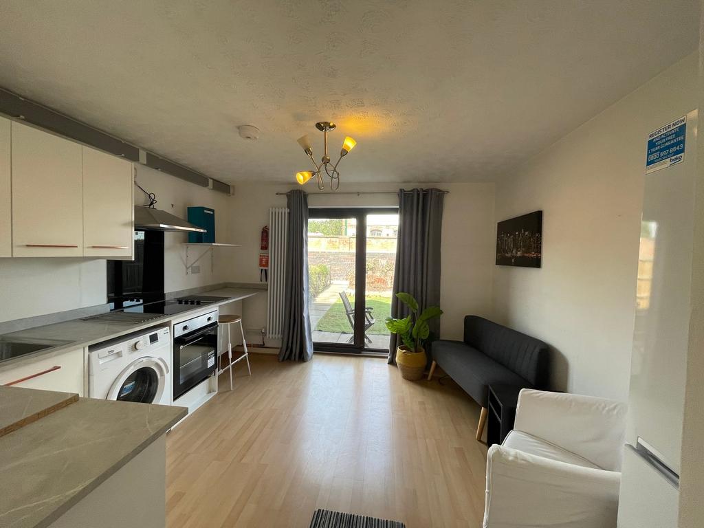 A bright and modern kitchenette with ample spac...