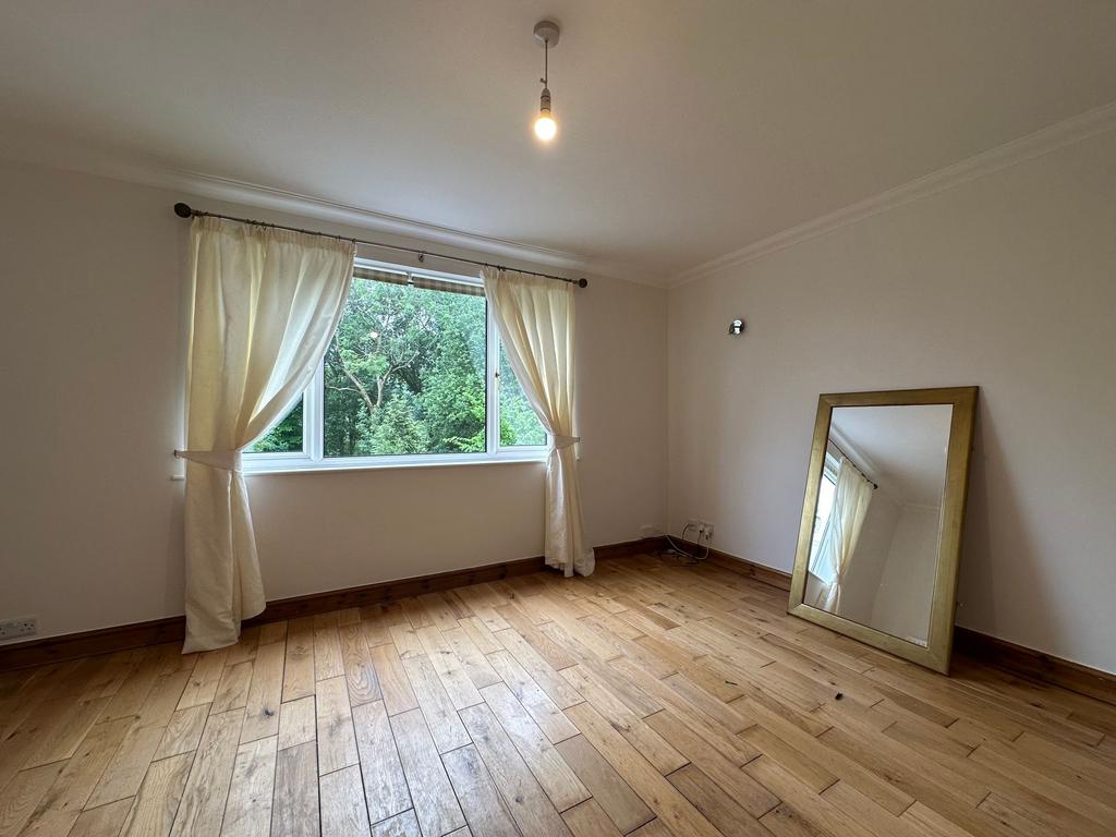 Bright, freshly painted bedroom with large wind...