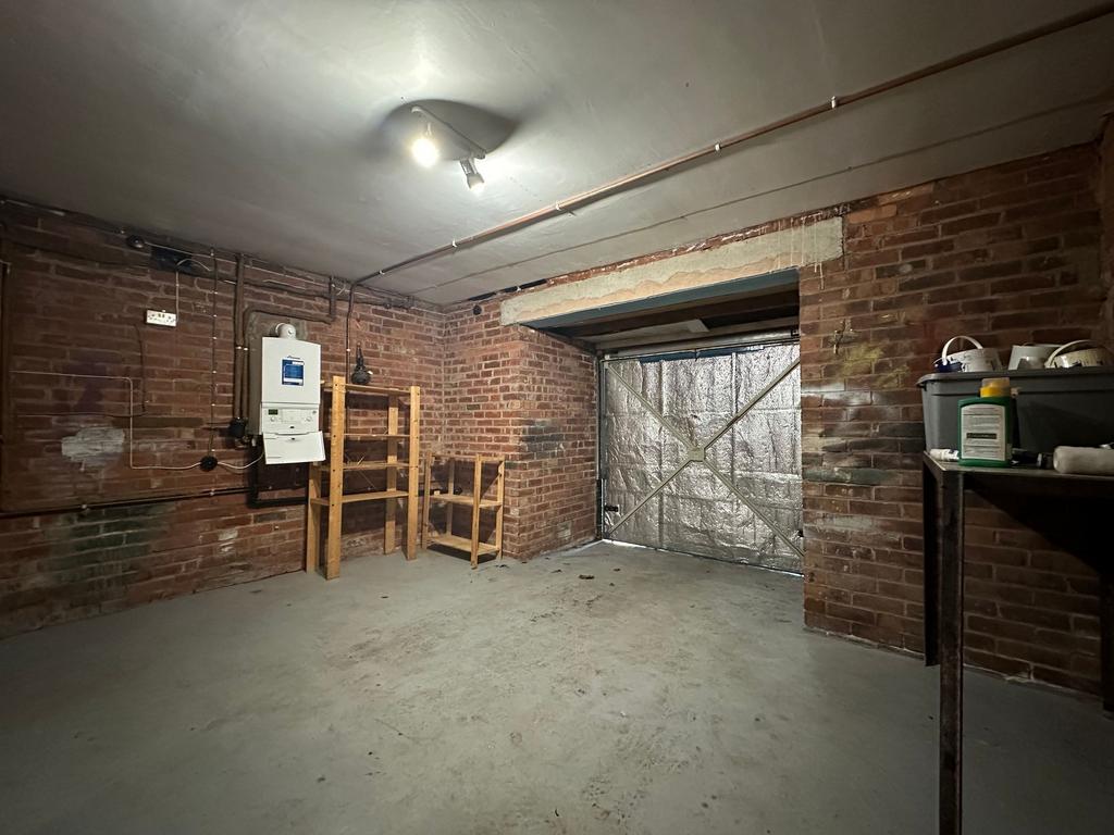 Secure brick-walled garage/storage room with sh...