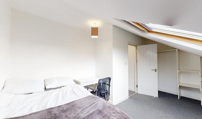Bright attic double bedroom with a skylight, fi...