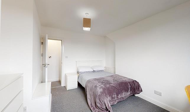 Bright, neutrally decorated double bedroom with...