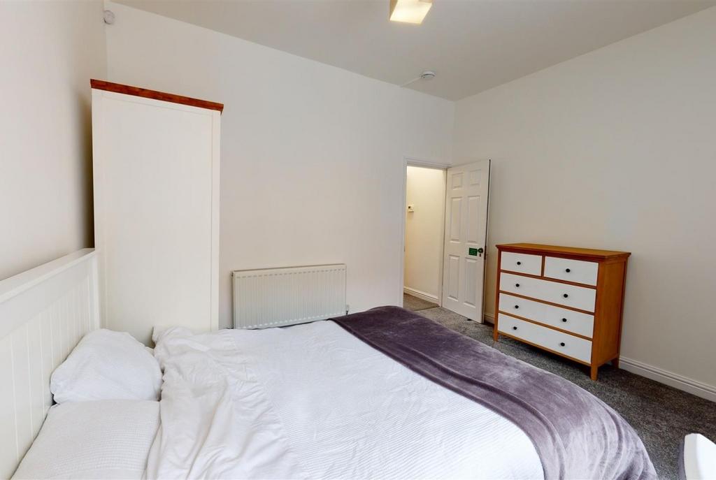 Bright, neatly presented bedroom with a comfort...