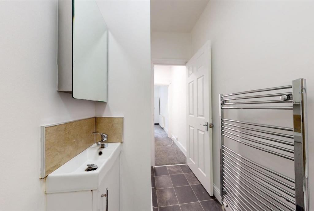 Bright, modern bathroom with a slim basin, mirr...