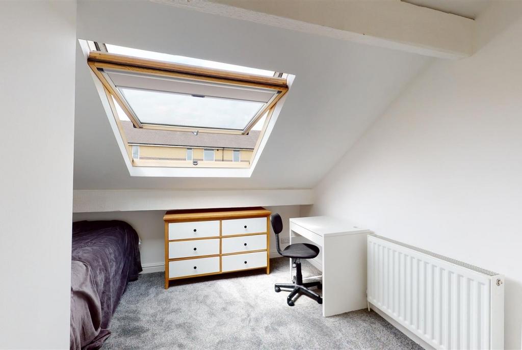 Bright attic bedroom with a large skylight, neu...