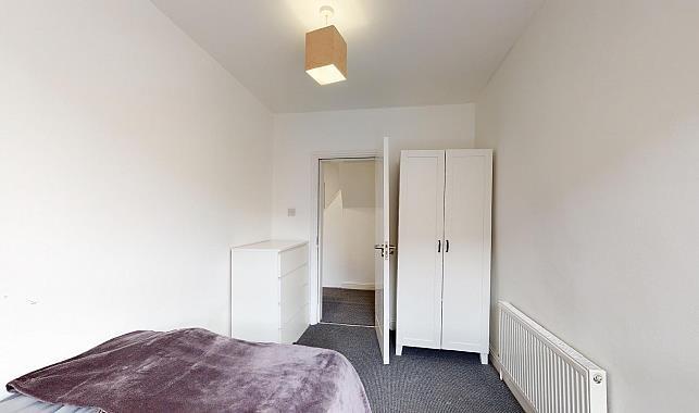 Simple, neutral single bedroom with a fitted wa...