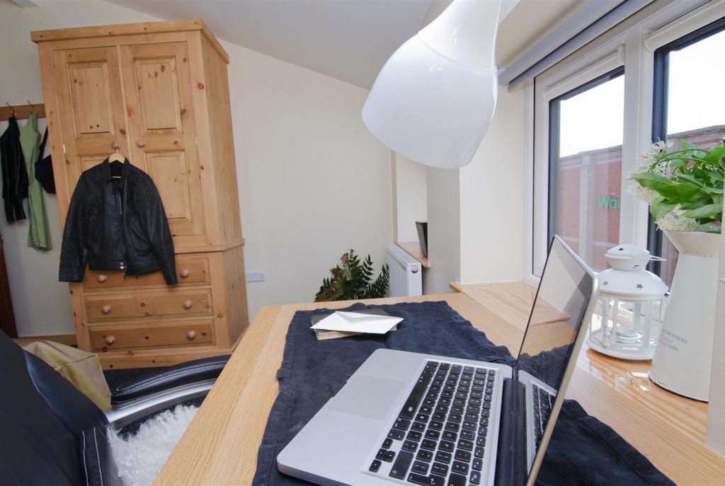 Bright and cosy bedroom with a study area by a ...