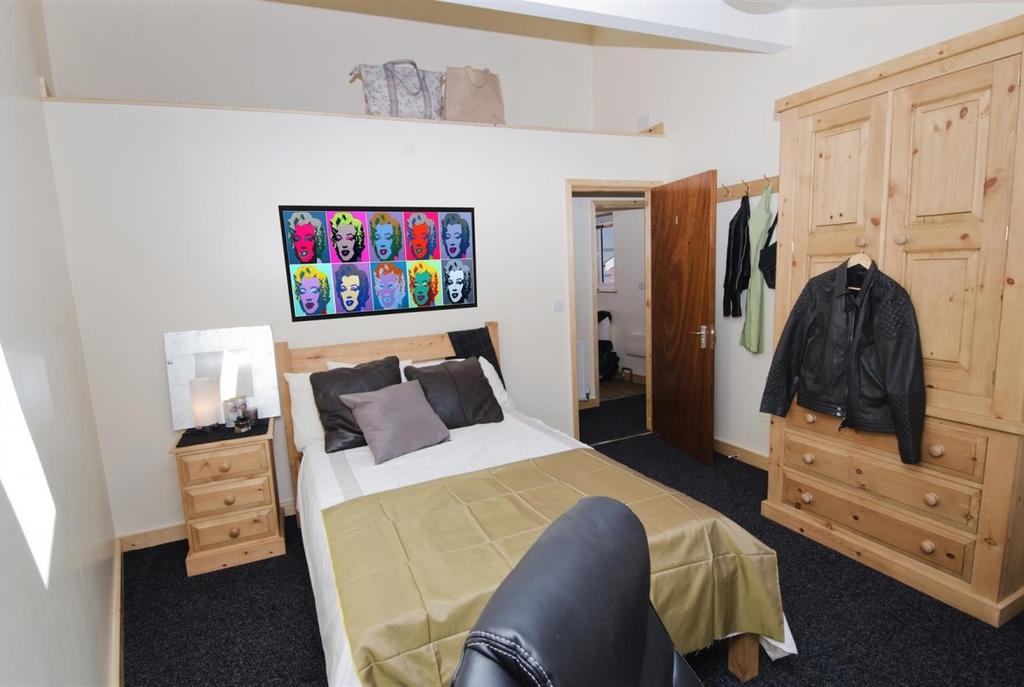 Bright, well-kept bedroom with a comfortable do...