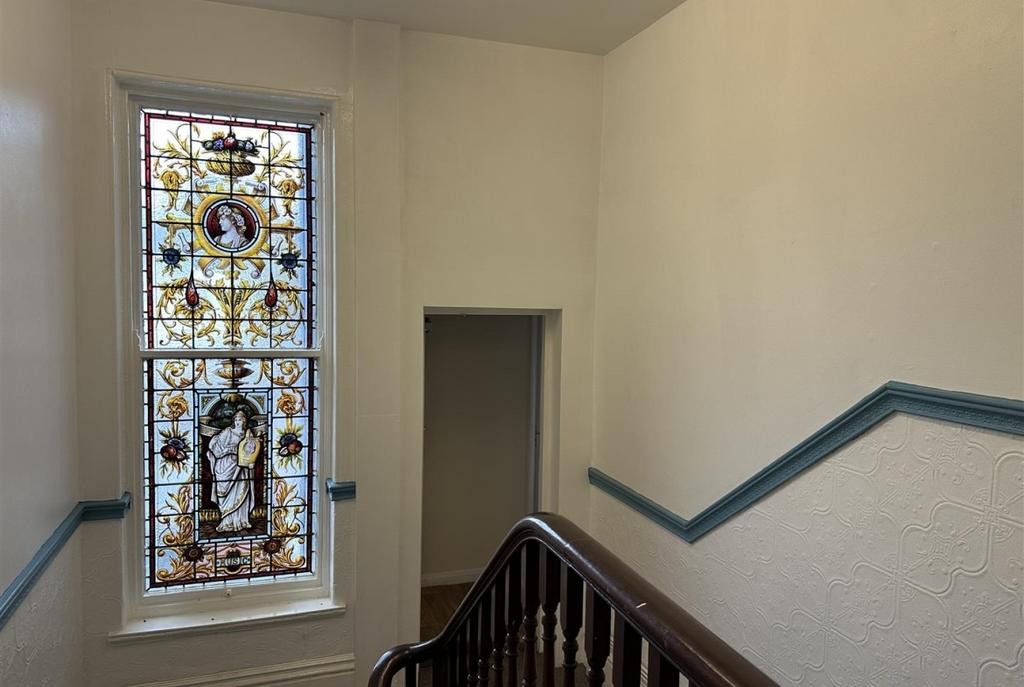 Well-maintained stairwell with decorative stain...
