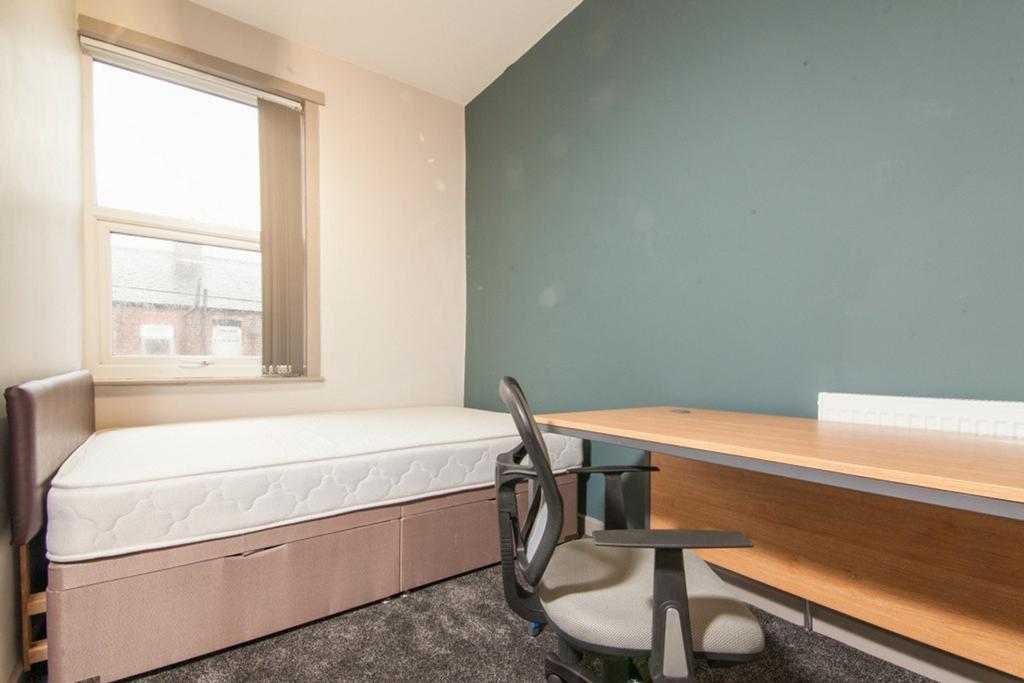 This inviting double bedroom features a comfort...