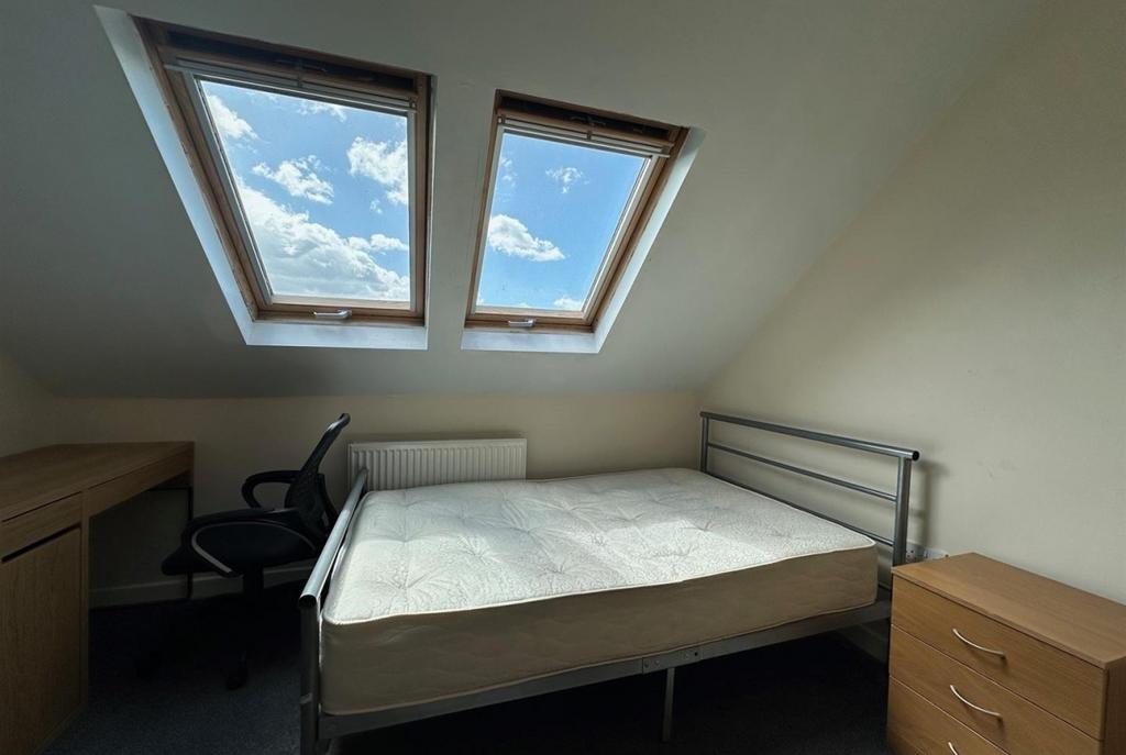 Bright attic double bedroom with two skylight w...