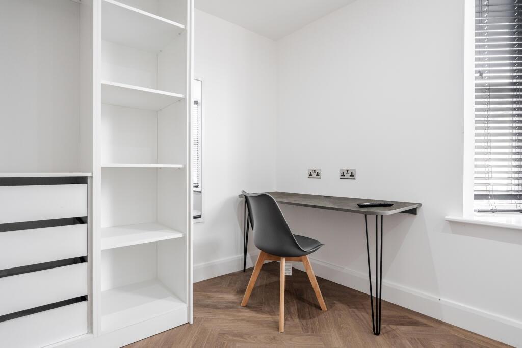 A bright and tidy study area with a sleek desk ...