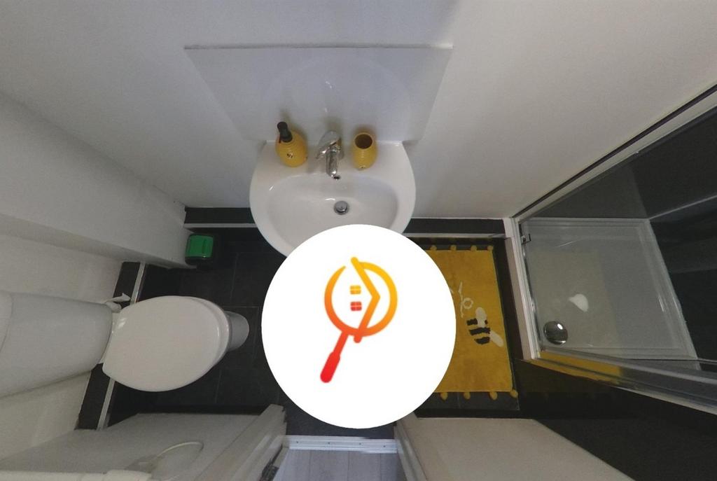 Compact, modern bathroom with a white basin, to...