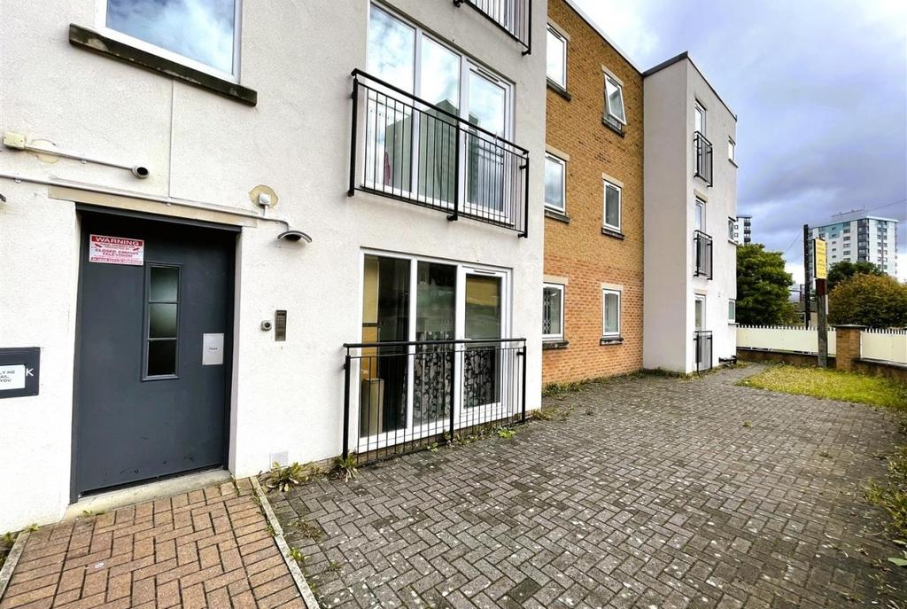 Modern apartment block entrance with private pa...