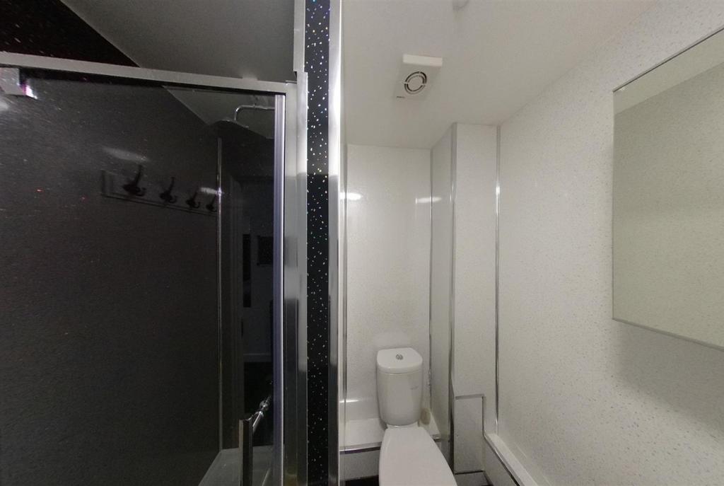 Modern white bathroom with a shower cubicle, to...