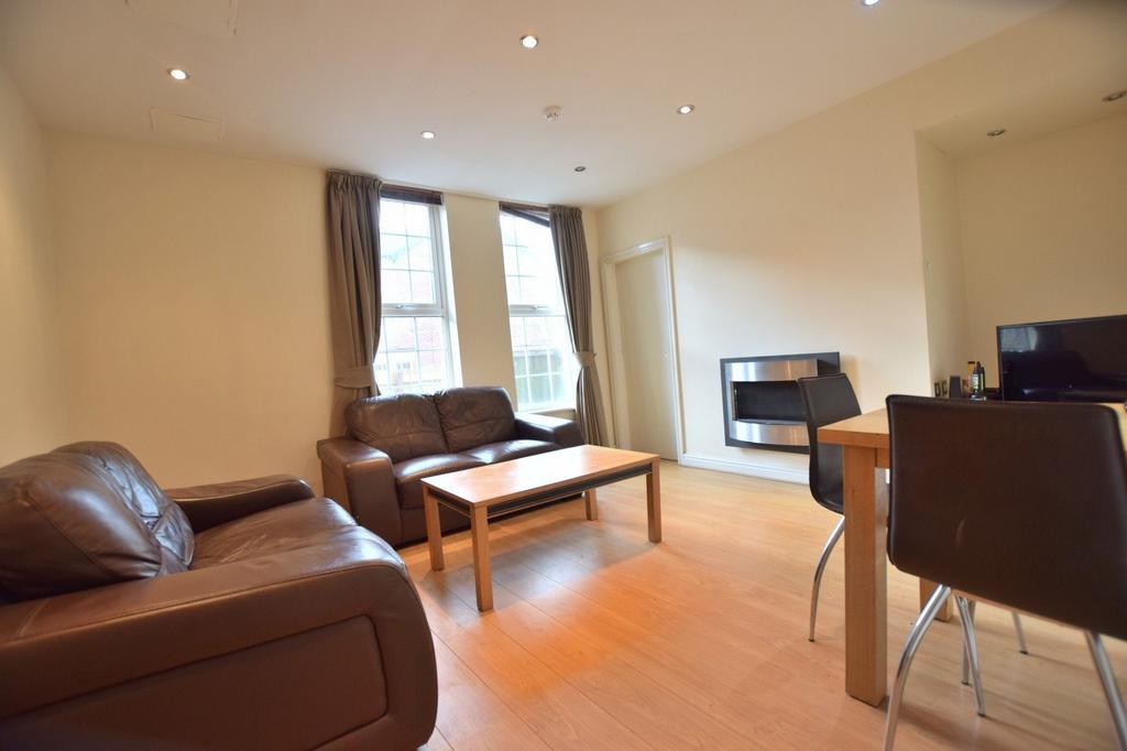 Bright, modern living room with large sash wind...