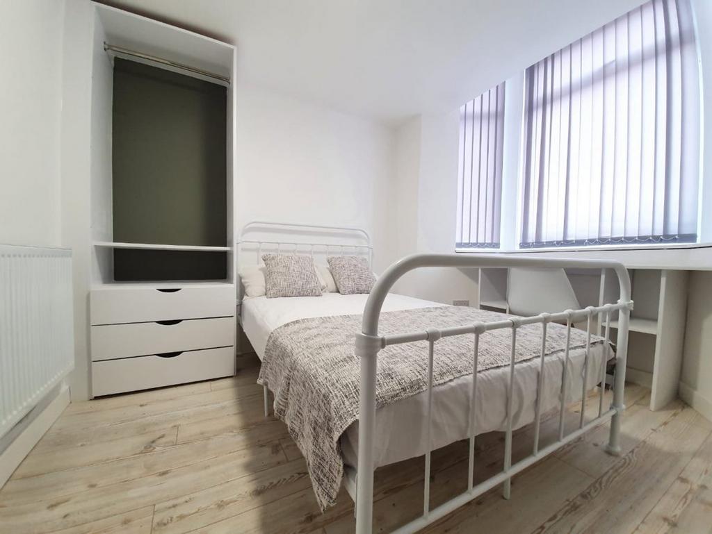 A bright and tidy double bedroom featuring ampl...