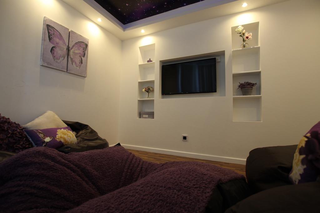 A cozy, well-lit living room featuring comforta...