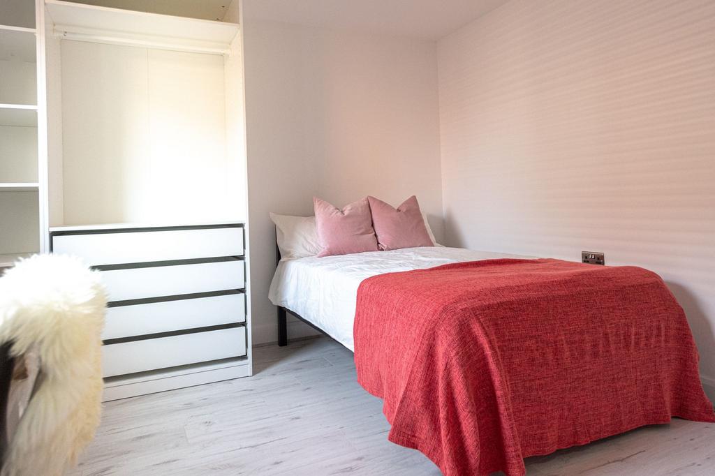 A bright and inviting double bedroom featuring ...