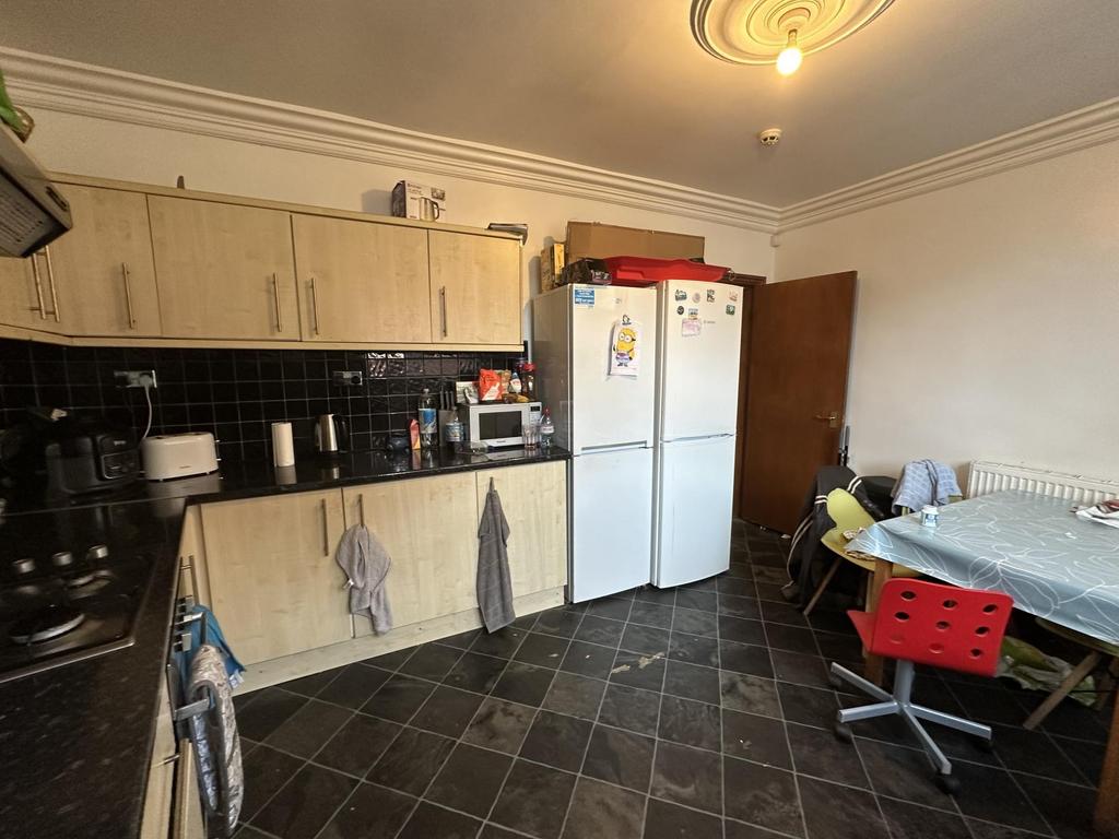A spacious and well-maintained kitchen featurin...