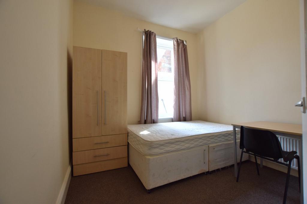 Simple, neutrally decorated bedroom with a doub...