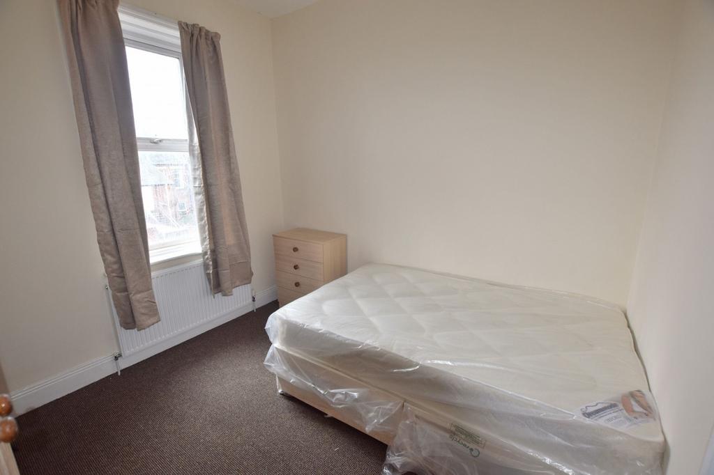 Bright, simple bedroom with a large window and ...